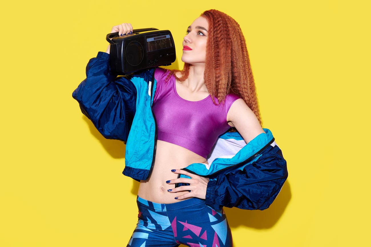 Young lady with a boom box with yellow background
